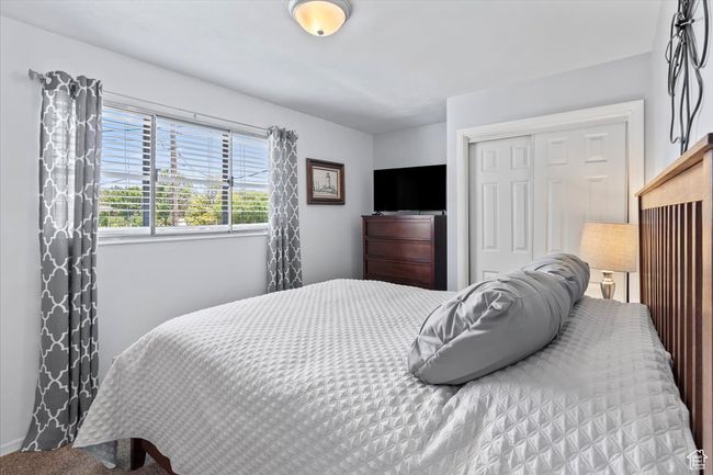 Primary bedroom featuring a closet and carpet flooring with attached 1/2 bath | Image 12