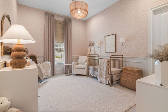 Bedroom with a nursery area, a wainscoted wall, carpet, and a decorative wall | Image 28