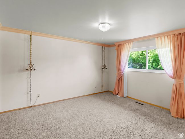 Carpeted empty room featuring baseboards | Image 13