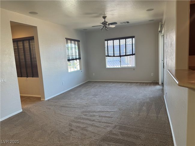 Carpeted spare room featuring ceiling fan and baseboards | Image 10