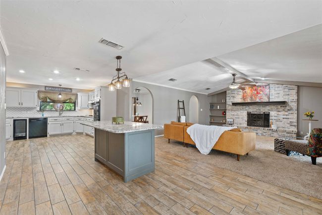Kitchen featuring dishwasher, wine cooler, island, and open floor plan | Image 12