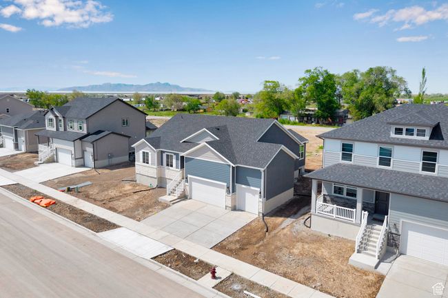 View of front of property featuring stairs, a residential view, covered porch, driveway, and a mountain view | Image 33