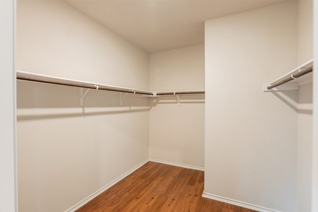 Walk in closet with wood finished floors | Image 27