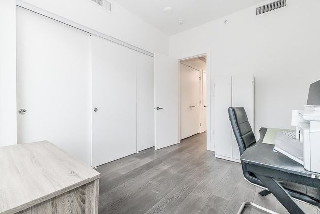 Office with wood finished floors and visible vents | Image 24