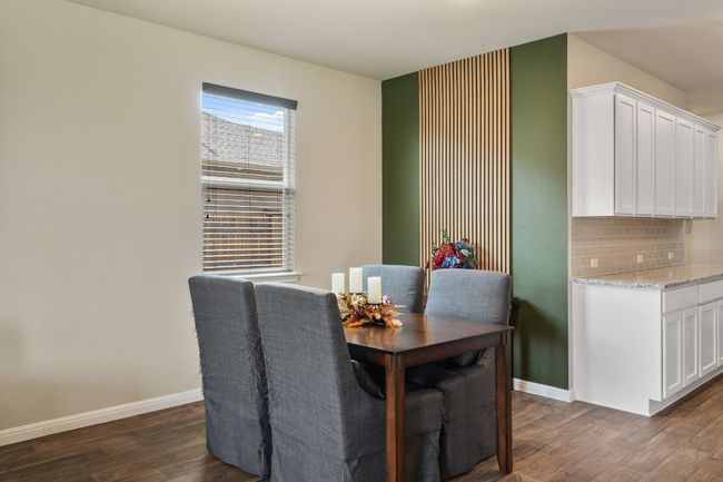 Dining space featuring dark wood-style flooring and baseboards | Image 10