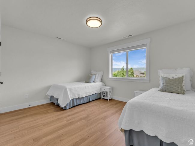 Bedroom featuring light wood-type flooring and baseboards | Image 42