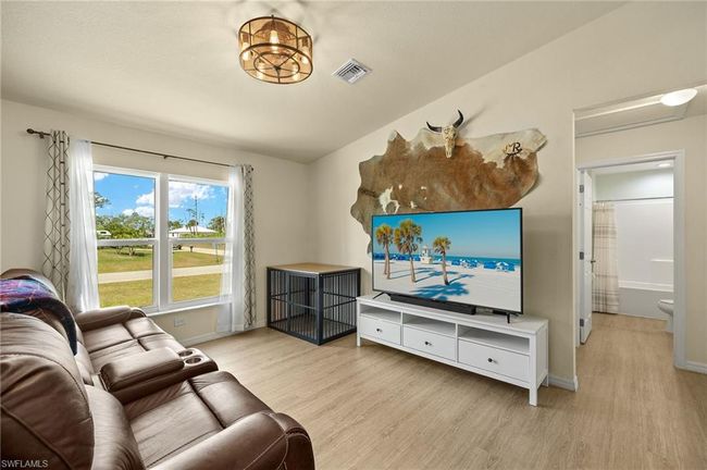 Living area featuring visible vents, baseboards, and wood finished floors | Image 4