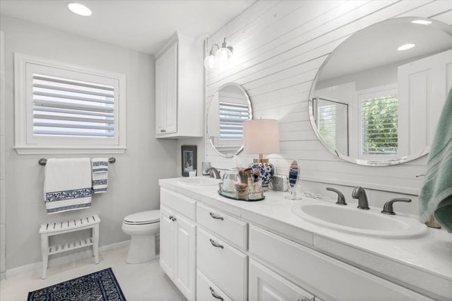 Bathroom featuring toilet, double vanity, and plenty of natural light | Image 28
