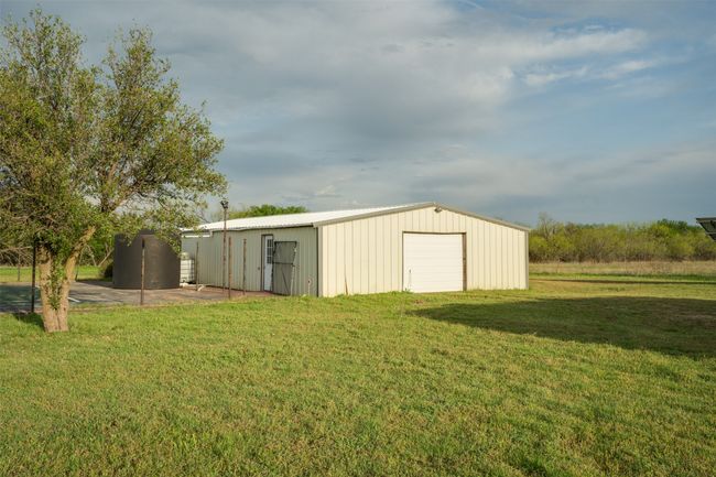 View of pole building featuring a lawn | Image 38