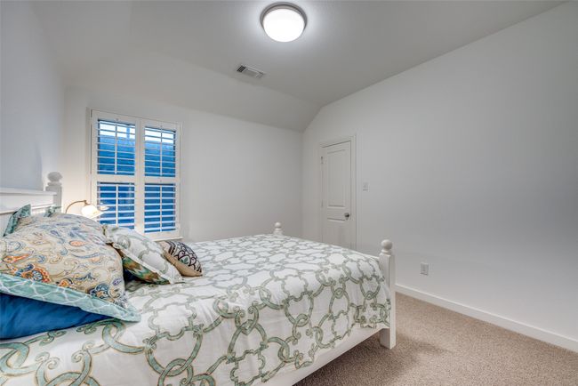 Carpeted bedroom featuring visible vents, baseboards, and vaulted ceiling | Image 27
