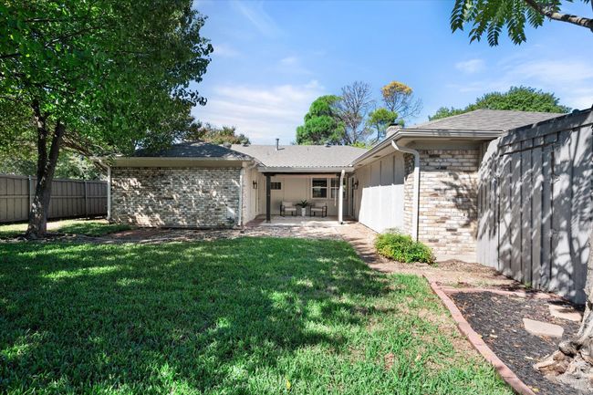 Private fenced-in back yard features covered sitting area. | Image 35