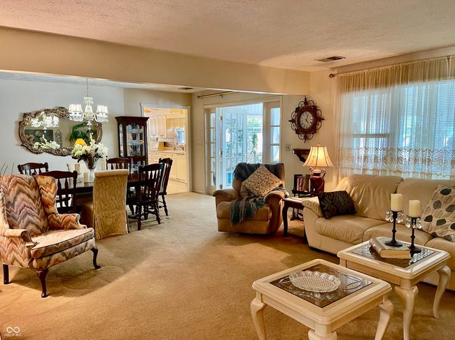 living area with carpet and a textured ceiling | Image 20