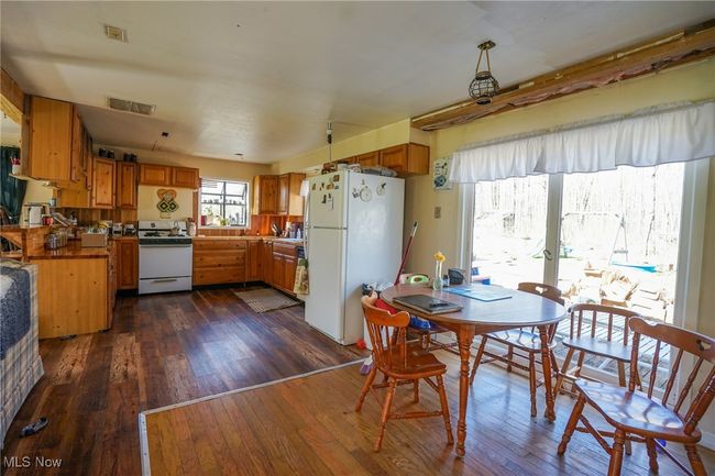 Dining space with visible vents and dark wood-style floors | Image 8