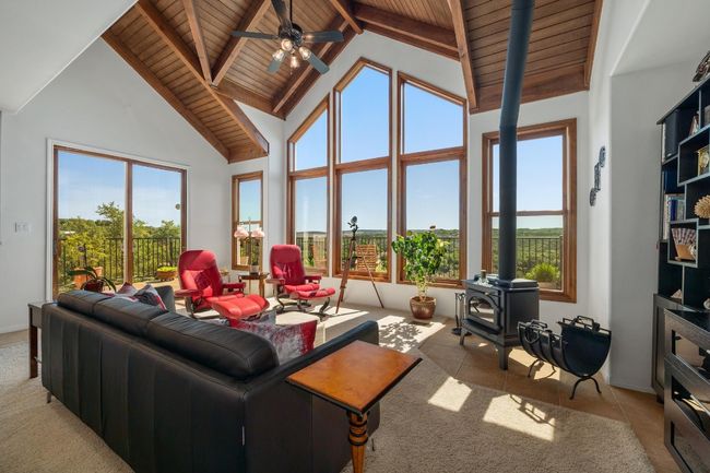 Large windows for views, wood burning stove. | Image 7