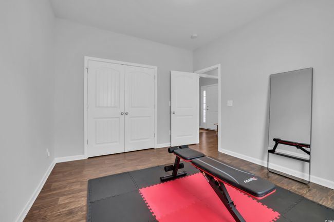 Workout room with baseboards and wood finished floors/second guest bedroom | Image 14