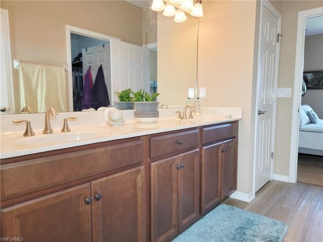Bathroom with wood finished floors, a sink, double vanity, and connected bathroom | Image 30