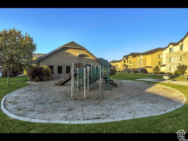 Community play area featuring a lawn and a residential view | Image 16
