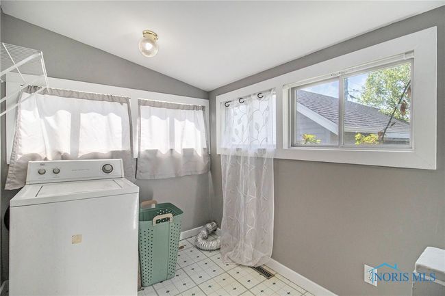 Conveniently located off the kitchen, the main floor laundry room adds everyday ease, while the mudroom provides a practical drop zone for coats, shoes, and bags—perfect for busy households or outdoor lifestyles. | Image 17