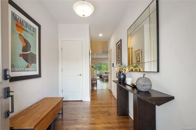 Corridor featuring coat closet and hardwood flooring | Image 2