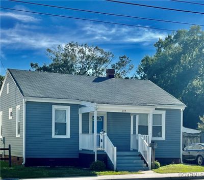 View of front of house with covered porch and a front yard | Image 2