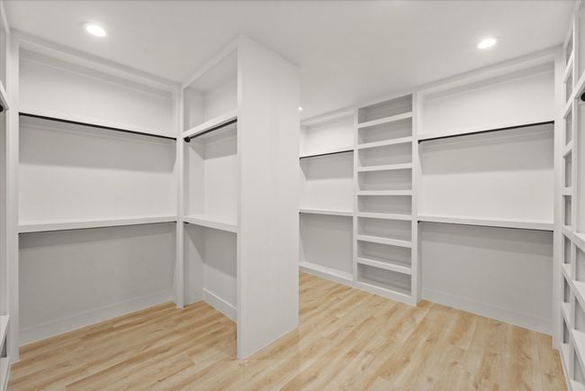 Spacious closet with wood finished floors | Image 18