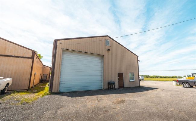 Detached garage featuring asphalt driveway | Image 13