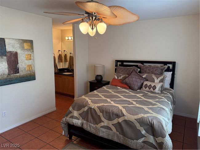 Tiled bedroom with baseboards, a ceiling fan, and ensuite bathroom | Image 9
