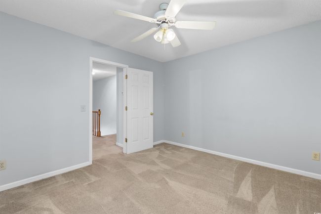 Empty room with carpet flooring and ceiling fan | Image 17