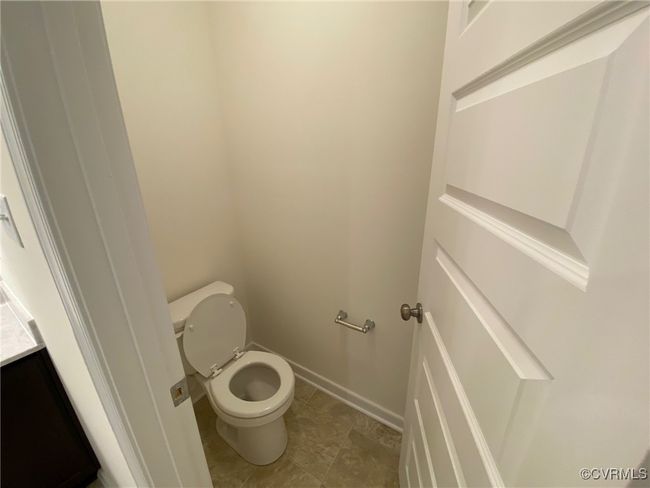 Bathroom featuring toilet, tile patterned flooring, and baseboards | Image 19
