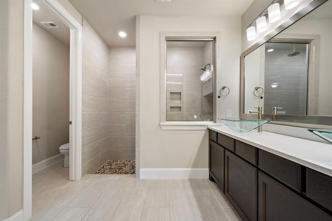 The walk-in shower also features a peek through window. | Image 17