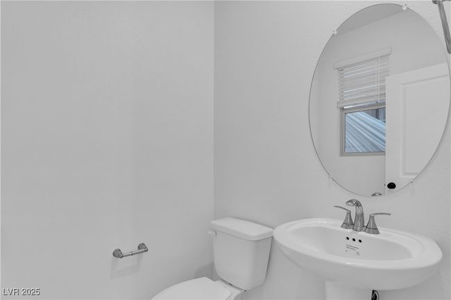 Bathroom with toilet and a sink | Image 7