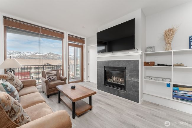 The cozy, gas fireplace and large flatscreen will provide many evenings of relaxation, movie/game nights and luxurious entertaining | Image 11