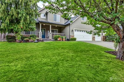 Welcoming covered front porch, easy access and large front yard. | Image 2