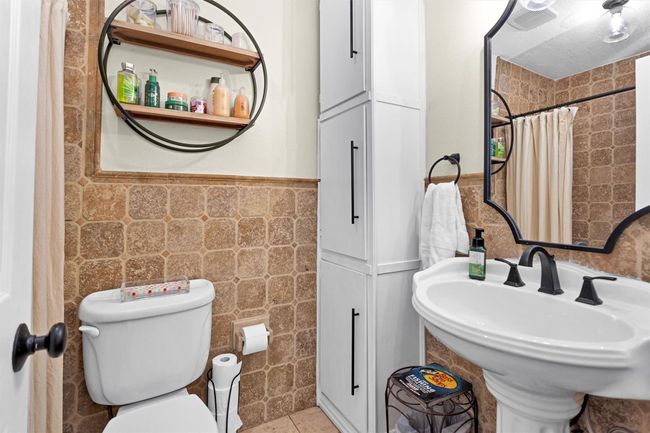 The updated secondary bath is conveniently located between all the other bedrooms. It offers a tub/shower combo and custom built cabinetry. | Image 23