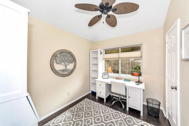 Office area featuring dark wood-style flooring, a ceiling fan, and baseboards | Image 14
