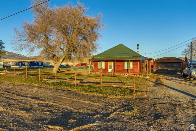 View of the front of the West home featuring a 2-car garage and a grass yard | Image 20