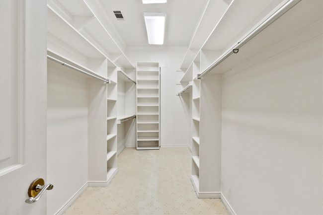 ONE of the primary closets, don't miss the "hidden" cedar closet behind the shelving. (There are three closets in the primary bath). | Image 26