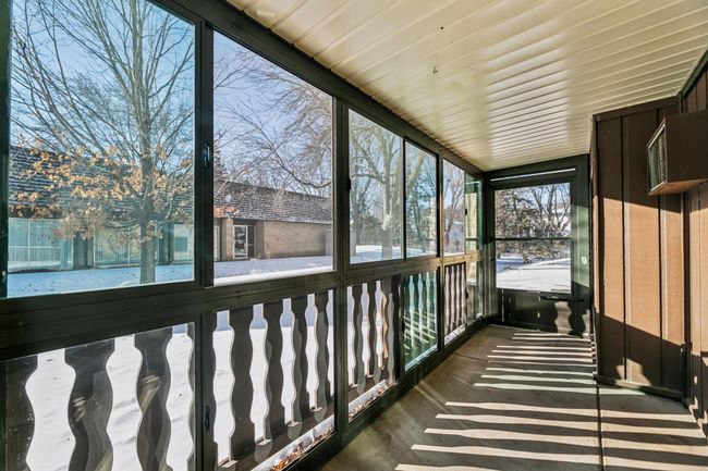 Enjoy hanging outside in your sunlight 3 season porch, just steps from the pool. | Image 7
