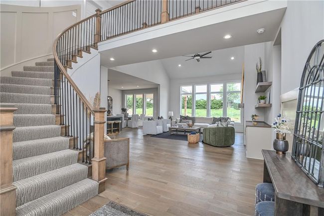 Living room with hardwood / wood-style flooring, high vaulted ceiling, and ceiling fan | Image 5