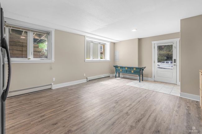 Unfurnished room with baseboard heating, a baseboard radiator, wood finished floors, plenty of natural light, and recessed lighting | Image 28