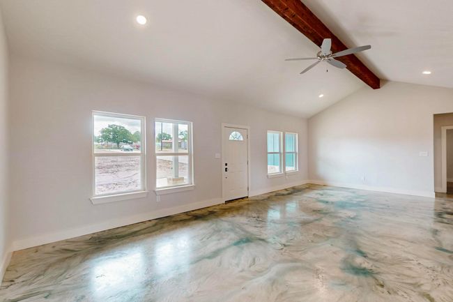 Unfurnished living room featuring healthy amount of natural light, concrete floors, recessed lighting, and a ceiling fan | Image 16