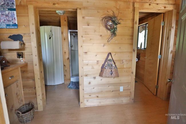 Corridor with wood walls and light wood-style floors | Image 13