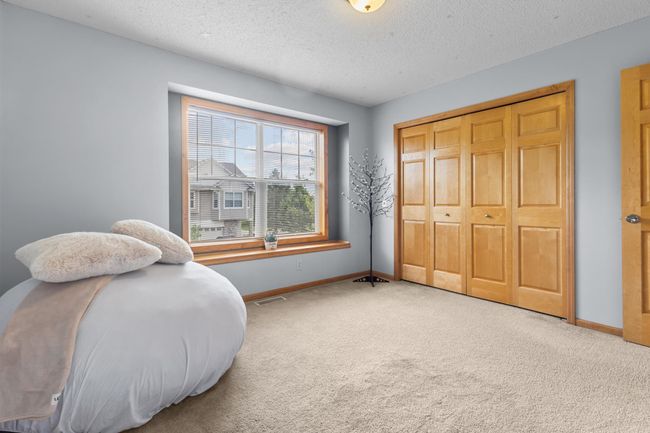 Upper Level 2 Bedroom with large window and ample closet space | Image 19