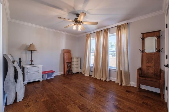 Misc room featuring ceiling fan, dark hardwood / wood-style floors, and ornamental molding | Image 17