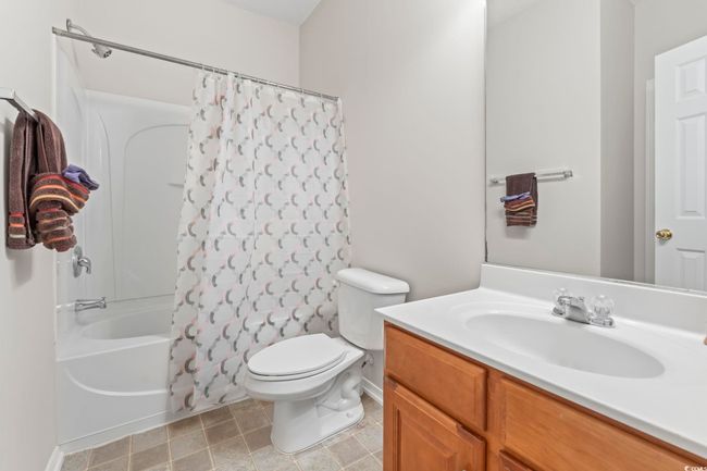 Full bathroom featuring vanity, shower / bath combination with curtain, and toilet | Image 19