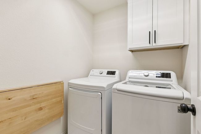 Laundry room featuring washer and dryer and cabinet space | Image 14