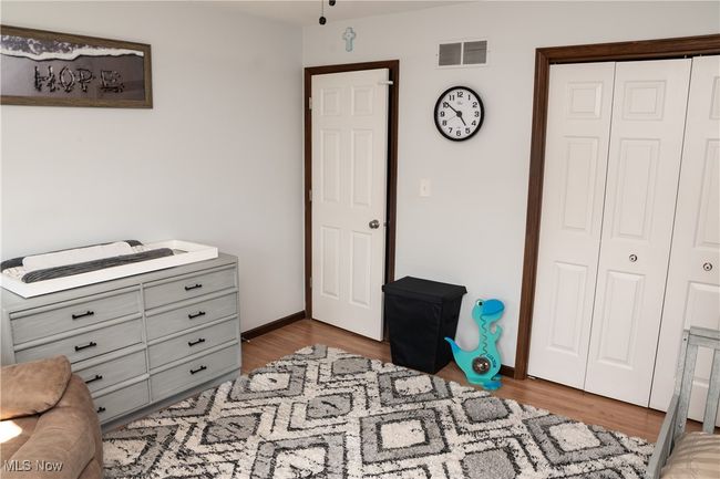 Bedroom with a closet and wood finished floors | Image 35