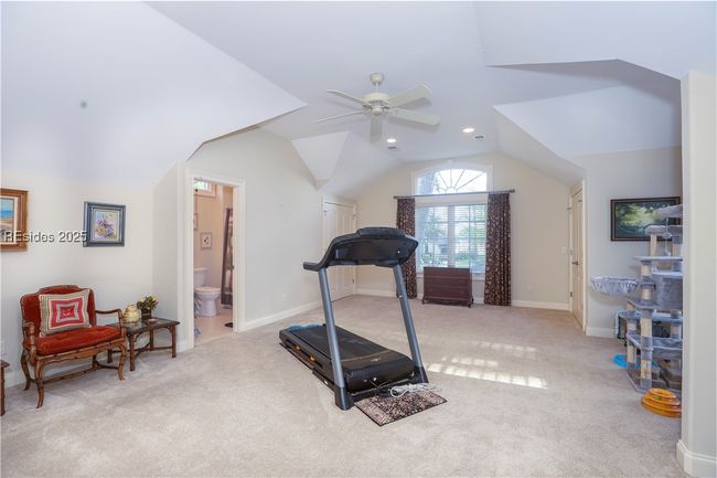 Upstairs is the BONUS bedroom being used for TV viewing and fitness. It has an en-suite full bathroom as well as 2 walk-in California-style closets and access to the walk-in full house attic storage. | Image 36