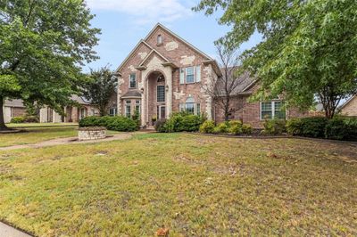 Front of property featuring landscaped front lawn and mature trees | Image 2