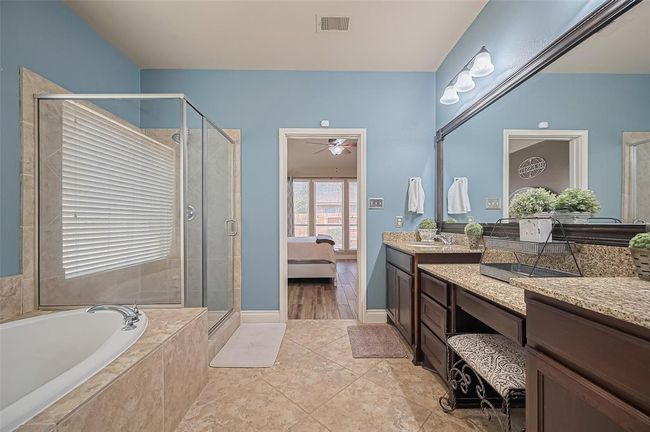 The ensuite offers a generous walk-in closet alongside a commode thoughtfully tucked away for privacy, creating an ideal space to prepare for the day ahead. | Image 26